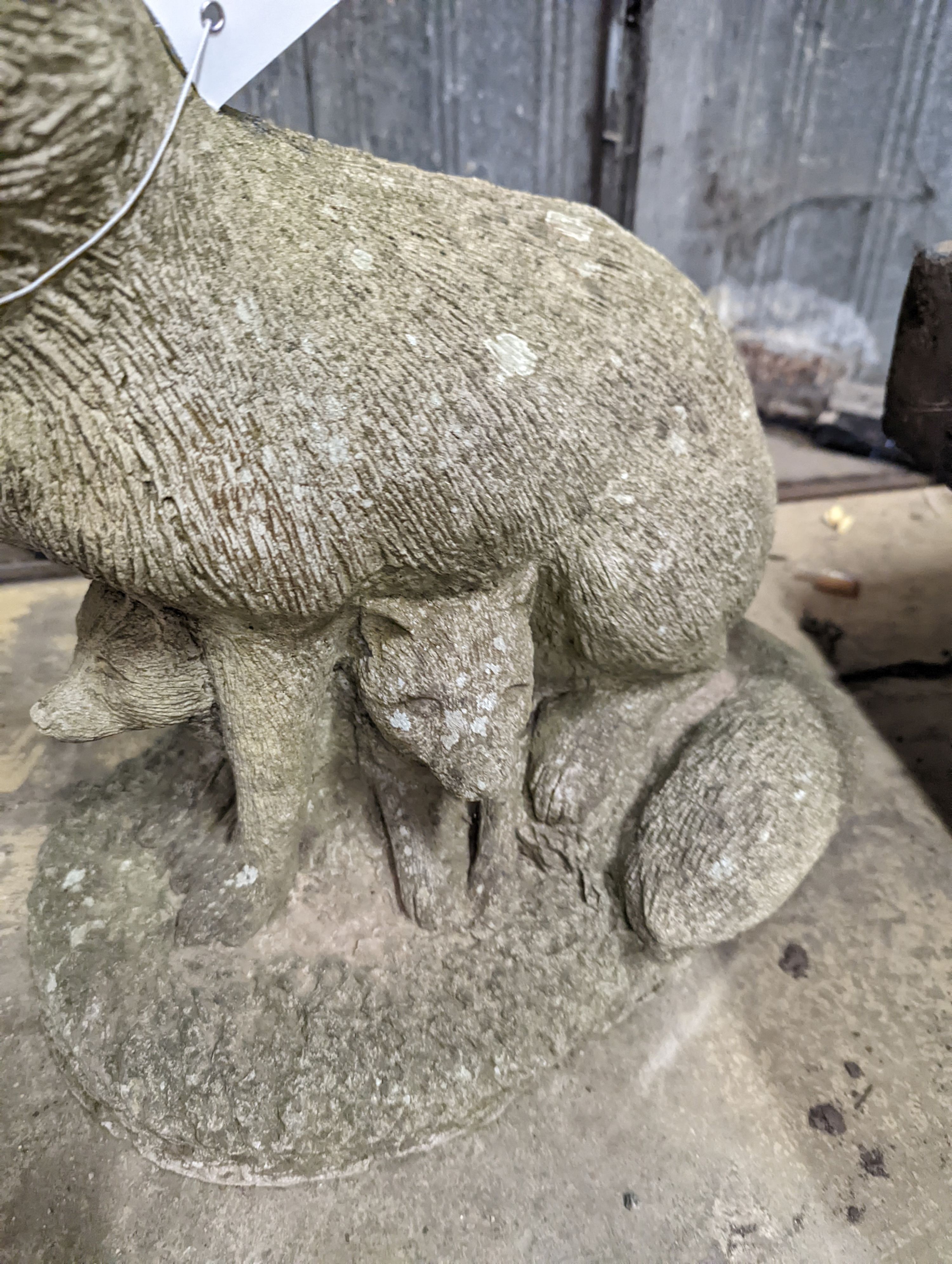 A reconstituted stone garden ornament modelled as a fox with cub, height 42cm